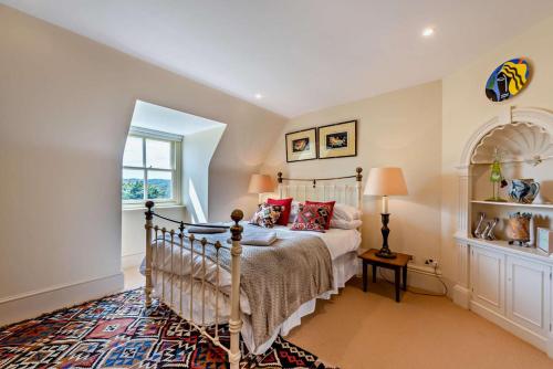 a bedroom with a bed and a window at Denswood House in Brightling