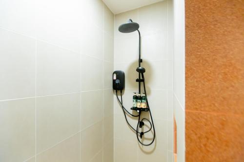 a phone hanging on a wall in a bathroom at Vita Villa - Modern 2BR At Heart of Phetchaburi in Phetchaburi