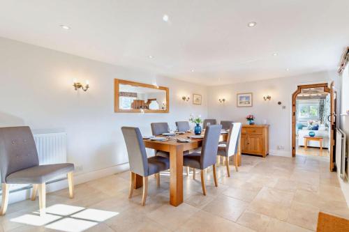 a dining room with a table and chairs at The Granary - Ticehurst in Ticehurst