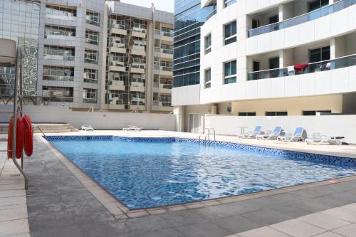 a swimming pool in the middle of a building at Dubai Marina 1BR with Balcony, Near Metro, Walk to JBR beach & Marina Promenade in Dubai