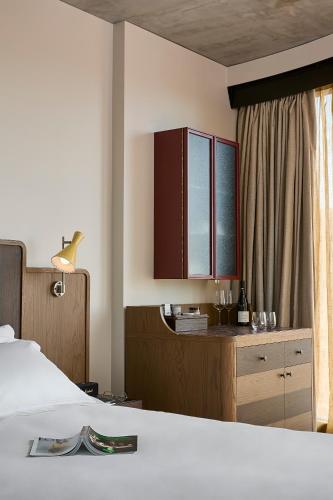 a bedroom with a bed and a cabinet and a window at Hannah St Hotel Melbourne in Melbourne