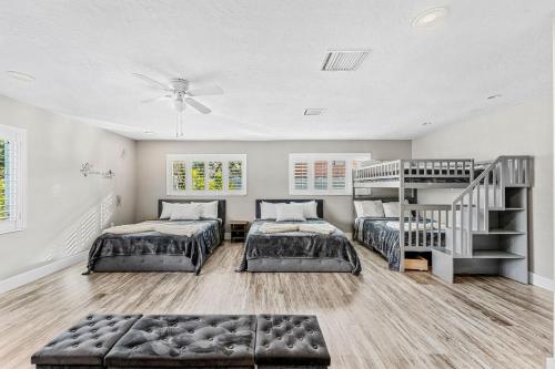 a bedroom with two beds and a ladder at 332 Formosa Drive in Cocoa Beach