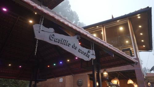 a sign for a restaurant in front of a building at Castillo De Woods , The Private Luxury Villa , 8 BHK, Vattavada in Kottakamboor