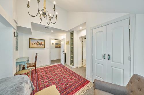 a living room with a red rug and a chandelier at Houston Towers Inn, Adults-Only, Downtown, Med Ctr, NRG in Houston