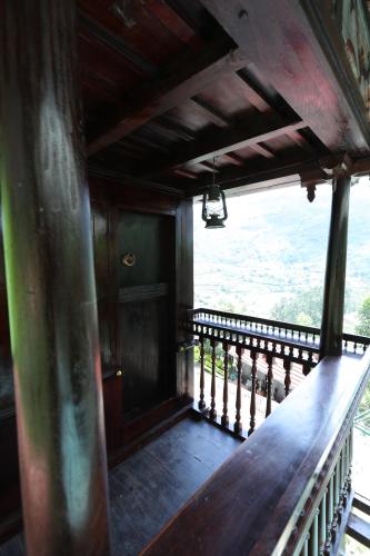 a balcony with a wooden railing and a view at Castillo De Woods , The Private Luxury Villa , 8 BHK, Vattavada in Kottakamboor