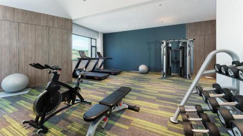 a gym with cardio equipment in a room at Holiday Inn Express Xining Railway Station by IHG in Xining