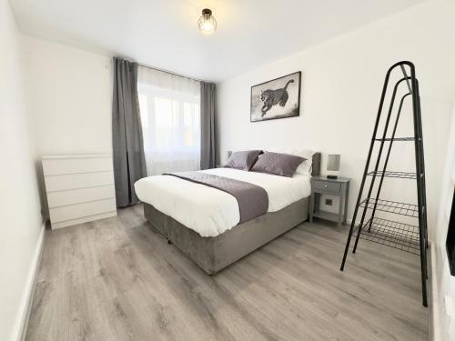 a bedroom with a bed and a ladder in it at The Cozy Hideaway - 2 Bedroom apartment with garden in Orpington with free Parking in Foots Cray