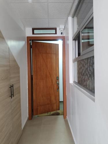 a hallway with a wooden door in a room at OCTAWAHOMe in Cayambe