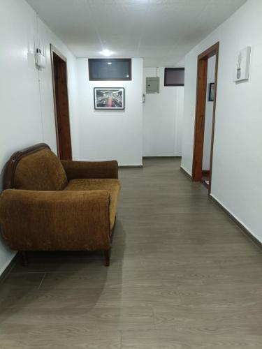 a living room with a couch and a hallway at OCTAWAHOMe in Cayambe