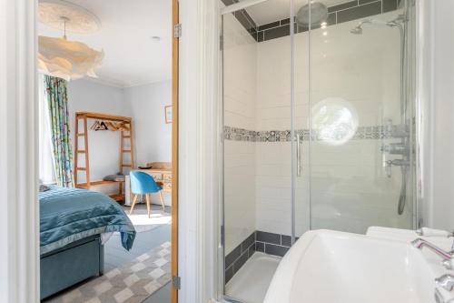 a bathroom with a shower and a sink and a tub at Sea Vista - Dovercourt in Harwich