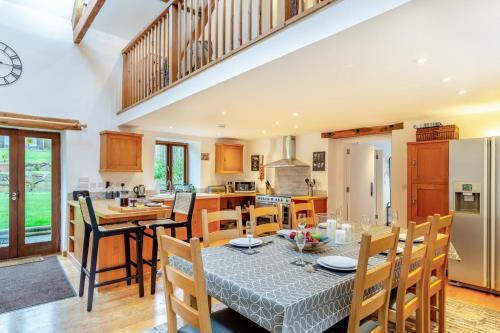 a kitchen and dining room with a table and chairs at The Moohey in Downderry