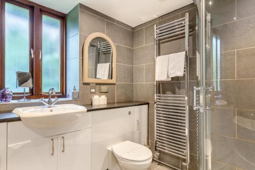a bathroom with a toilet and a sink and a shower at The Moohey in Downderry
