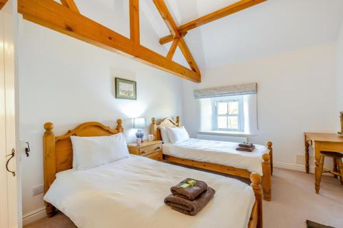 une chambre avec deux lits et une fenêtre dans l'établissement Southwaite Cottage, à Outhgill