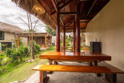 a picnic table on the porch of a house at Lá Retreat near Ba Na Hills in Thôn Phước Sơn