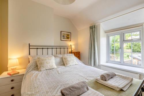 a bedroom with a large bed and a window at Bonnings Cottage in Barrington