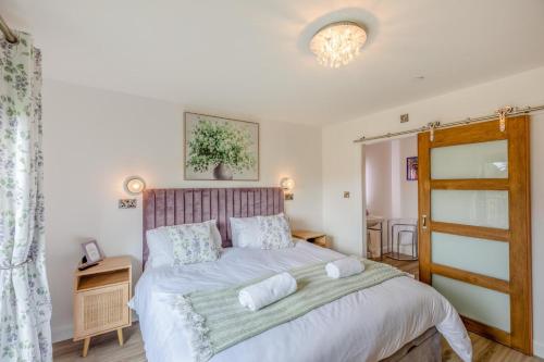 a bedroom with a bed with two pillows on it at Titw Tomos Las in Berriew