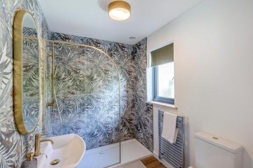a bathroom with a shower and a sink at Titw Tomos Las in Berriew