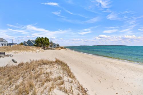a sandy beach with the ocean in the background at Hydrangeas by the Sea in Barnstable