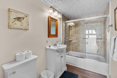a bathroom with a sink and a toilet and a shower at Hydrangeas by the Sea in Barnstable