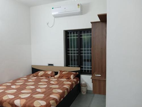 a bedroom with a bed and a dresser and a window at Licence To Chill Homestay Villa in Pūvār