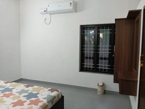 a bedroom with a bed and a window at Licence To Chill Homestay Villa in Pūvār