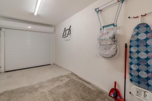 a garage with a door and a snowboard on the wall at Mays Place in Tenby