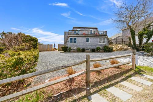 a house with a fence in front of it at Hydrangeas by the Sea in Barnstable