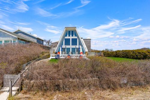 a house with a blue and white house on a hill at Hydrangeas by the Sea in Barnstable