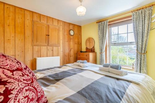 une chambre avec un grand lit et une fenêtre dans l'établissement The Olde Cottage - Hythe, à Hythe