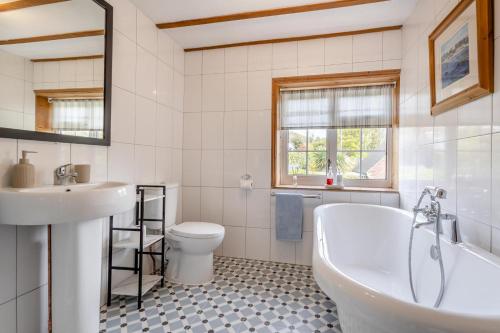 une salle de bain avec une baignoire, des toilettes et un lavabo dans l'établissement The Olde Cottage - Hythe, à Hythe