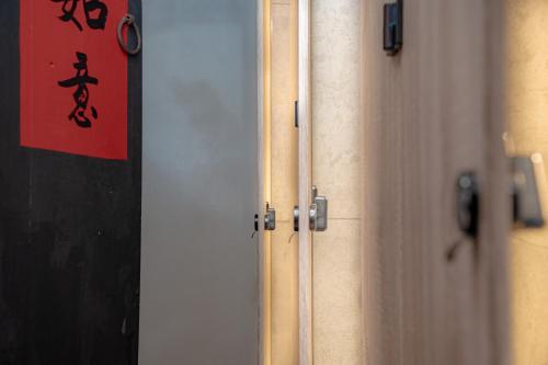 a group of doors with a red sign on it at Beishan Old Western Style Hostel in Jinning