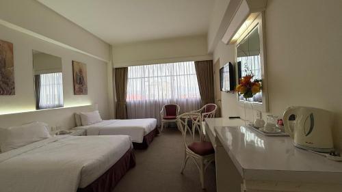 Postel nebo postele na pokoji v ubytování De Palma Hotel Ampang