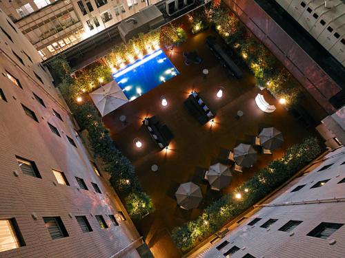 an overhead view of a building with plants and lights at Oriental Hotel Fukuoka Hakata Station in Fukuoka