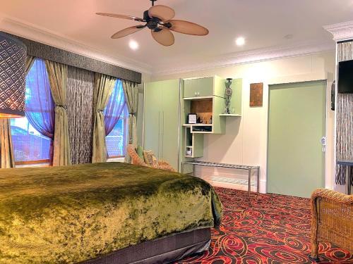 a bedroom with a bed and a ceiling fan at The Retreat at Froog Moore Park in Tamworth