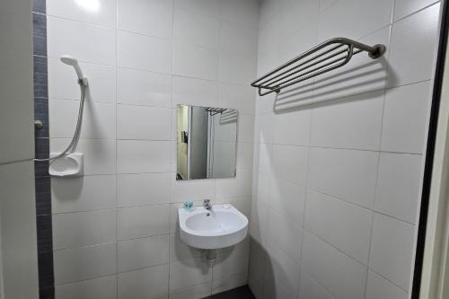 a white bathroom with a sink and a mirror at Fast Hotel Sri Gombak in Batu Caves