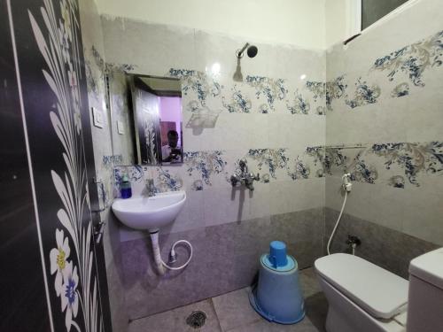 a bathroom with a sink and a toilet at A Cozy home away from home! in Hyderabad