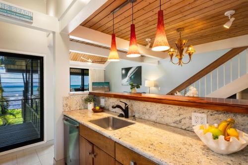 a kitchen with a sink and a window at Kahana Village 32 · KHV 32 Direct Oceanfront Views Remodeled 2BD in Kahana