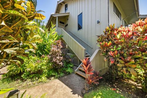 a house with a bunch of plants in front of it at Kahana Village 32 · KHV 32 Direct Oceanfront Views Remodeled 2BD in Kahana