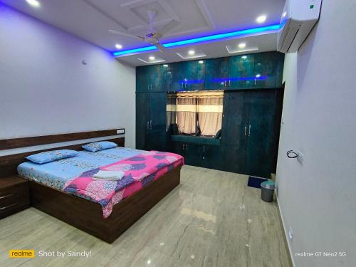 a bedroom with a bed and a blue light at A Cozy home away from home! in Hyderabad