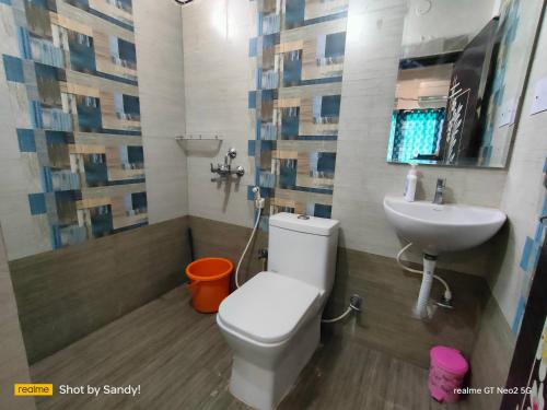 a bathroom with a toilet and a sink at A Cozy home away from home! in Hyderabad