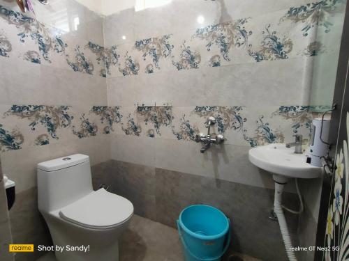 a bathroom with a toilet and a sink at A Cozy home away from home! in Hyderabad