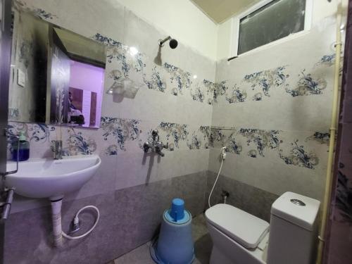 a bathroom with a sink and a toilet at A Cozy home away from home! in Hyderabad