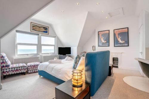 a bedroom with a bed and a chair and a window at White Water House in Pevensey