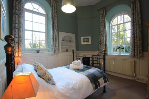 a bedroom with a bed with a stuffed animal on it at Monks Bridge in Crosby Ravensworth