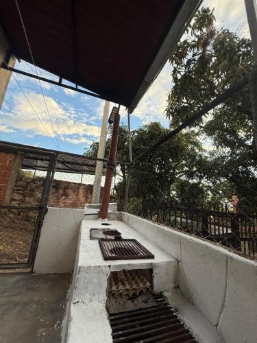 a porch with a bench on the side of a building at Amanecer Entre Montañas in Las Granjas
