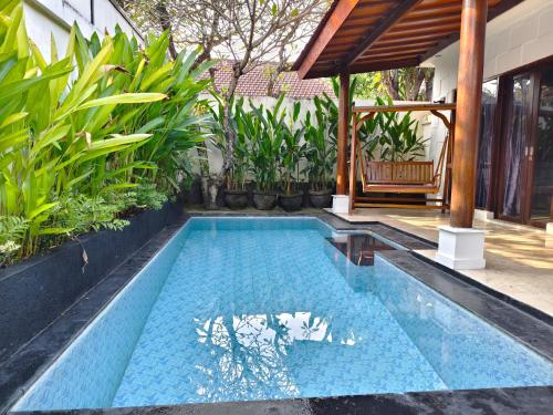 a swimming pool in the middle of a house at Private Pool Villas Kuta Bali in Kuta