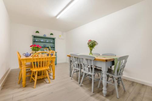 a kitchen and dining room with a table and chairs at Magnolia - Bude in Bude