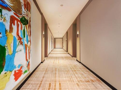 an empty hallway with a painting on the wall at Lux CABINS一方山水 in Guilin