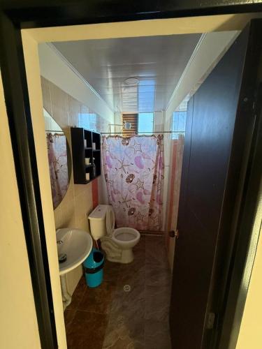 a bathroom with a toilet and a sink at Amanecer Entre Montañas in Las Granjas