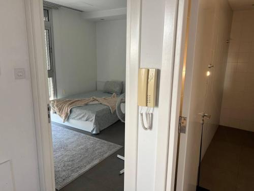 a bedroom with a bed in a room with a mirror at Jedi Hub Hostel in Limassol